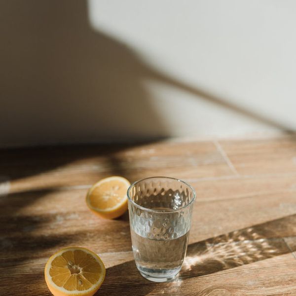 Healthy meal and a glass of water on a wooden table.